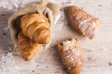 fresh croissants on wooden table