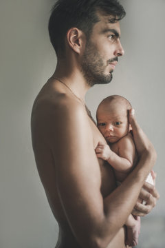 Portrait of loving father with baby at home. Sepia Toned
