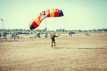 Man do some fold parachute arter landing his Paramotor in beace