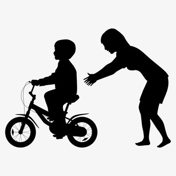 Mother teaches a child to ride a bike silhouette