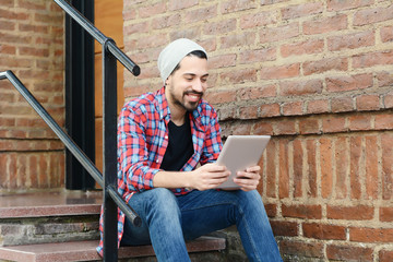 latin man using a tablet.