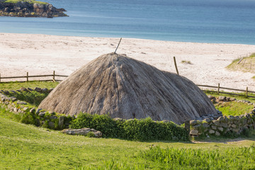 Ancient blackhouse or celtic croft preserved and restorend on a beach on Lewis in the Ouder Hebrides of Scotland