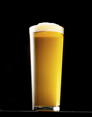 Wet Glass of fresh beer isolated on black background. With clipping path