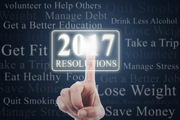 Hand touches resolutions with numbers 2017