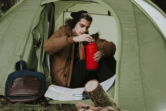 drinking coffee in camping tent in autumn