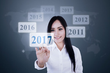 Pretty woman touching virtual numbers 2017