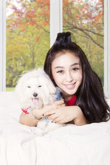 Woman and puppy playing in autumn season