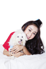 Woman hugging dog in studio