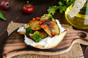 Fragrant Bruschetta with feta cheese, slices of eggplant and broccoli grilled. Close up