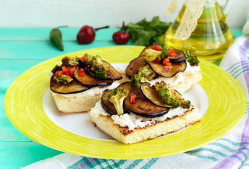 Fragrant Bruschetta with feta cheese, slices of eggplant and broccoli grilled. Close up