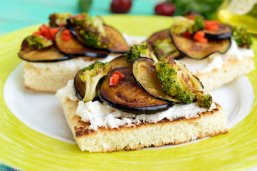 Fragrant Bruschetta with feta cheese, slices of eggplant and broccoli grilled. Close up