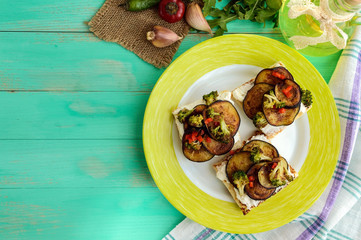 Fragrant Bruschetta with feta cheese, slices of eggplant and broccoli grilled. The top view