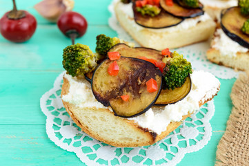 Fragrant Bruschetta with feta cheese, slices of eggplant and broccoli grilled. Close up