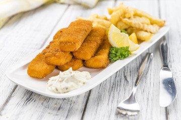 Fisch Sticks (close-up shot) on an old wooden table