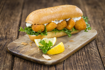 Roll with fried Fish Sticks (close-up shot)