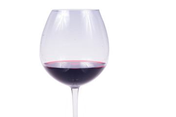 glass of red wine in the foreground on white background, isolated subject
