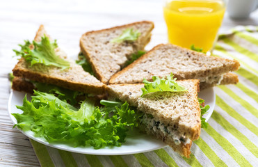 Toasts with cottage cheese and lettuce, and orange juice