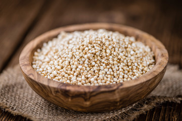 Portion of puffed Quinoa (selective focus) on an old wooden tabl