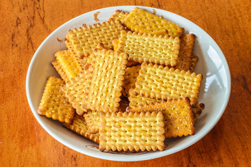 Stacked Butter Biscuits (close-up shot) on wooden background