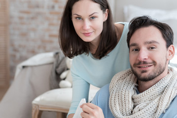 Happy optimistic couple looking at you