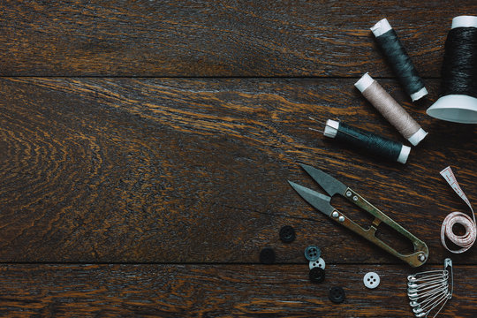 Top view tailor items on wooden background with copy space.