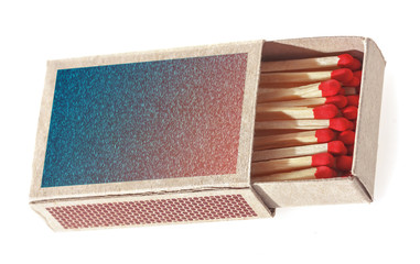 Matches in a matchbox. Isolated on white background. Soft focus.