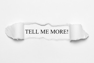 Tell me more! on white torn paper