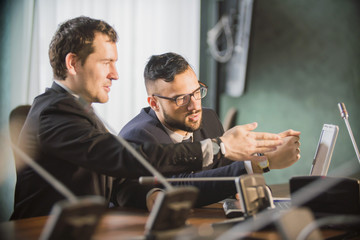 young manager listening to his colleague explanations, discussion of data, two partners negotiating