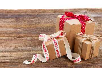 three handmade gift boxes on wooden table isolated on white background