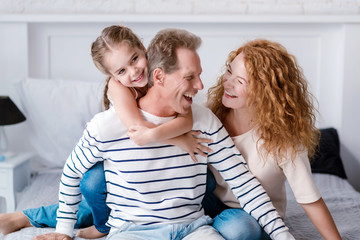 Smiling little girl having fun with her grandparents