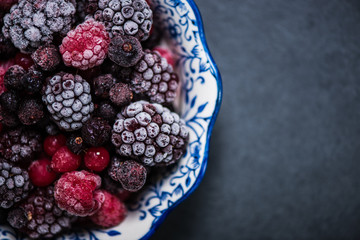 Bowl with frozen black forest fruits