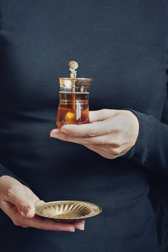Woman hand holding cup of tea