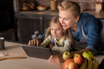 Daughter sitting with her mother in the kitchen