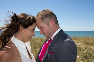 Cheerful married couple standing on the beach