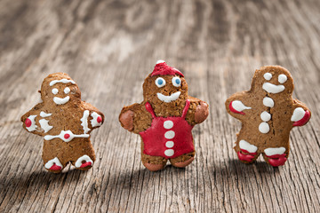 Tree decorated gingerman cookies on rustic wooden background