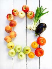 Variety of fresh summer fruits and vegetables - apples, peaches, tomatoes , eggplants and onion. Copy space for your text.