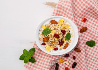 bowl of mix dried fruits muesli on white background