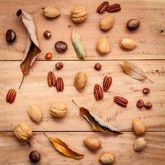 Fototapeta na wymiar Various kinds of nutshell walnuts kernels ,hazelnuts, almond ke