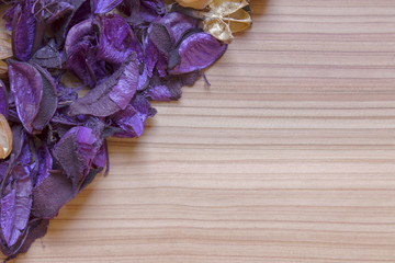 Purple flowers on a wooden floor.