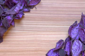 Purple flowers on a wooden floor.