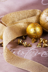 Fototapeta na wymiar Festive gold Christmas decorations on fabric background
