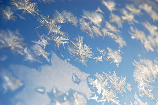 Sparkling snowflakes on a window. © dragunoff