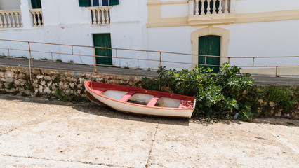 Fototapeta na wymiar The old boat on the beach in the old italian town. 