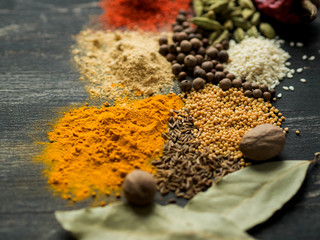 Colorful spices scattered on a black background

