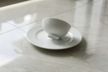 empty bowls, plates and cups on gray background