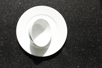 empty bowls, plates and cups on gray background