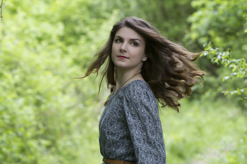 Portrait of beautiful brunette woman in fairy forest