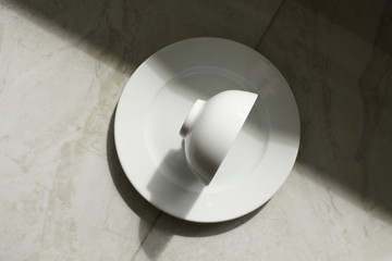 Obraz na płótnie Canvas empty bowls, plates and cups on gray background