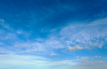 Blue sky with air white clouds. Beautiful heavenly background.