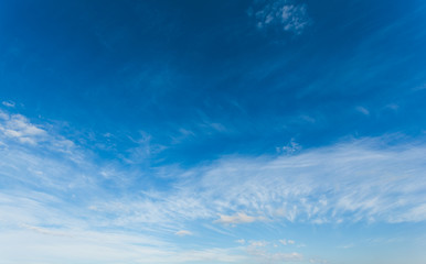 Naklejka na ściany i meble Blue sky with air white clouds. Beautiful heavenly background.